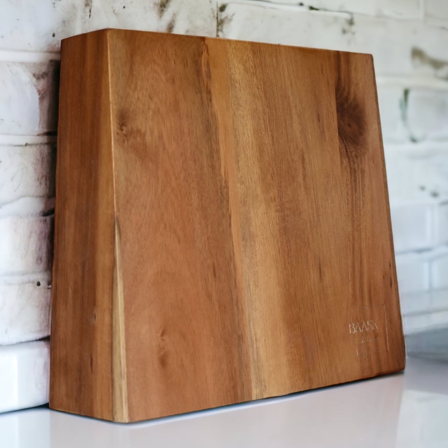 Acacia wood magnetic knife block without knives on white kitchen bench with white brick wall